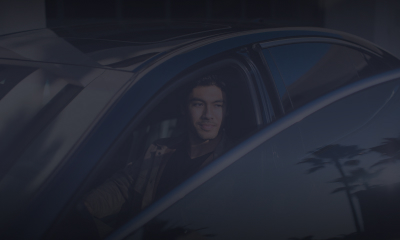 Man sitting in a Lexus, the sun is shining on his face.