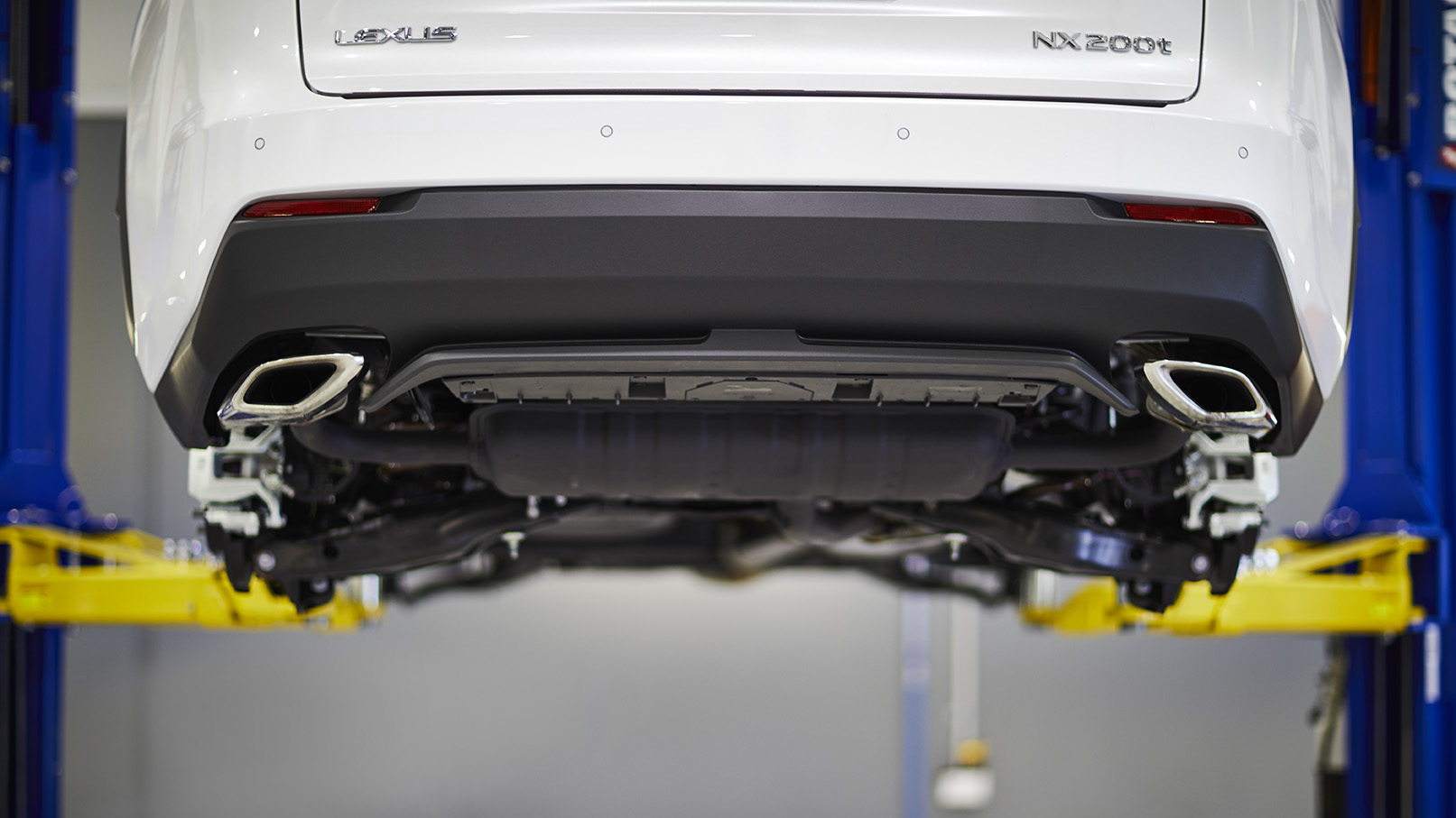 Lexus NX on a hoist while undergoing a scheduled service